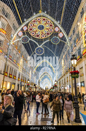 Crowds of people walking on Calle Marques de Larios street, decorated with Christmas decorations, Malaga, Spain Stock Photo