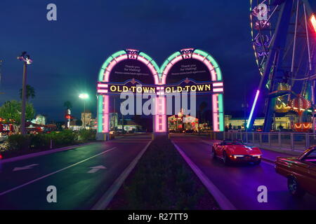 Orlando, Florida.  November 02, 2018 Vintage cars entering Saturday Nite Classic Car Show and Cruise, with arcs in background at Old Town Kissimmee. Stock Photo