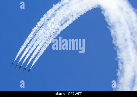 The Blue Angels F/A-18 Hornets perform a loop maneuver in line abreast formation. Stock Photo