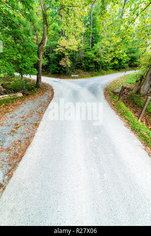 Vertical shot of a fork in the road that goes in two different directions.  A decision has to be made. Stock Photo