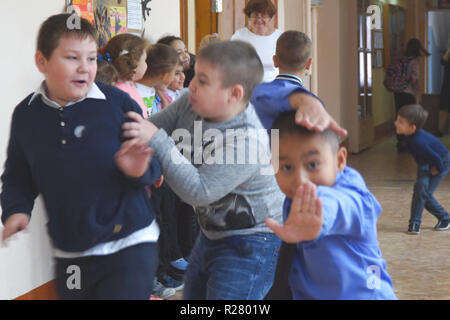 School children at recess in the hallway. Boys playing in the hallway of the school Stock Photo