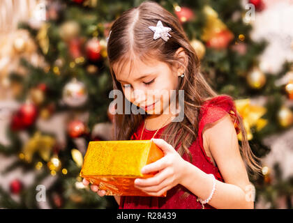 Happy little smiling girl with christmas gift box Stock Photo