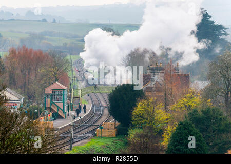 Corfe Castle, Dorset, UK.  17th November 2018. UK Weather.  A steam train on the Swanage Railway at Corfe Castle in Dorset leaving the station on a chilly and cloudy overcast morning.  Picture Credit: Graham Hunt/Alamy Live News Stock Photo