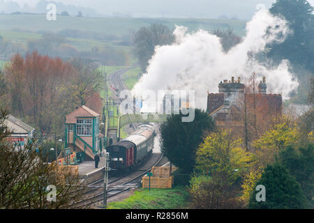 Corfe Castle, Dorset, UK.  17th November 2018. UK Weather.  A steam train on the Swanage Railway at Corfe Castle in Dorset leaving the station on a chilly and cloudy overcast morning.  Picture Credit: Graham Hunt/Alamy Live News Stock Photo