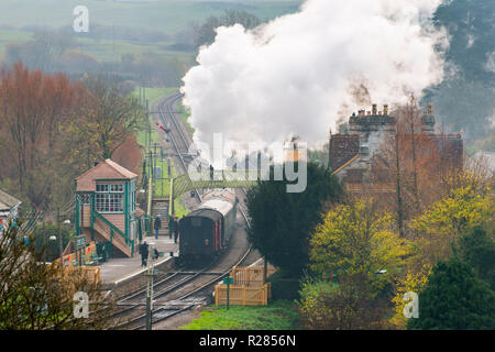 Corfe Castle, Dorset, UK.  17th November 2018. UK Weather.  A steam train on the Swanage Railway at Corfe Castle in Dorset leaving the station on a chilly and cloudy overcast morning.  Picture Credit: Graham Hunt/Alamy Live News Stock Photo