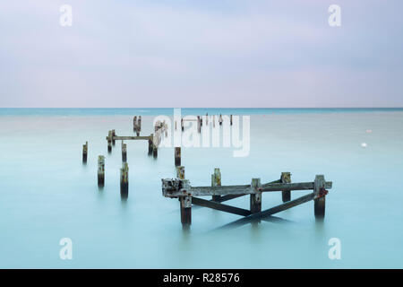 Swanage, Dorset, UK.  17th November 2018. UK Weather.  The remains of the old pier at the seaside town of Swanage in Dorset on a chilly and cloudy overcast start to the morning.  Picture Credit: Graham Hunt/Alamy Live News Stock Photo