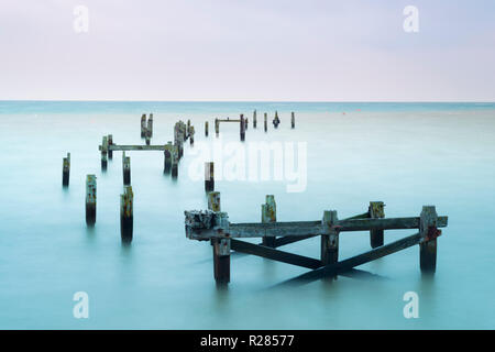 Swanage, Dorset, UK.  17th November 2018. UK Weather.  The remains of the old pier at the seaside town of Swanage in Dorset on a chilly and cloudy overcast start to the morning.  Picture Credit: Graham Hunt/Alamy Live News Stock Photo