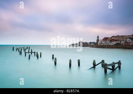 Swanage, Dorset, UK.  17th November 2018. UK Weather.  The remains of the old pier at the seaside town of Swanage in Dorset on a chilly and cloudy overcast start to the morning.  Picture Credit: Graham Hunt/Alamy Live News Stock Photo