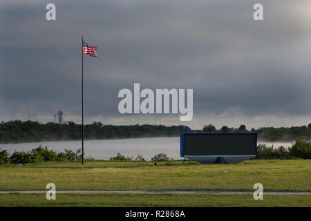 Kennedy Space Center, USA. 16th November 2018. The American flag is flying at Kennedy Space Center Florida. The countdown clock counts the time until Orion and the ESM fly into the sky. Launch complex 39A is in the distance. Credit: George Wilson/dpa/Alamy Live News Stock Photo