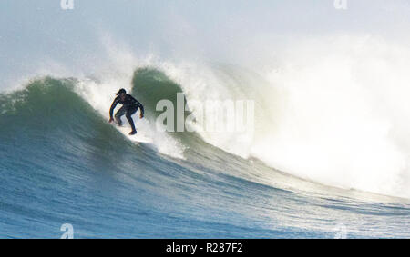 Big wave UK surfing and dangerous rocks Stock Photo