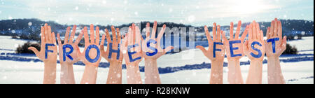 Hands Building Frohes Fest Means Merry Christmas, Winter Scenery As Background Stock Photo