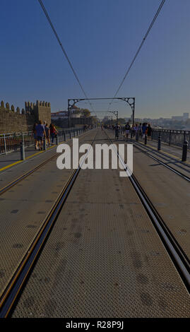 A late afternoon capture crossing the upper deck of the Dom Luis I Bridge in Porto, Portugal Stock Photo