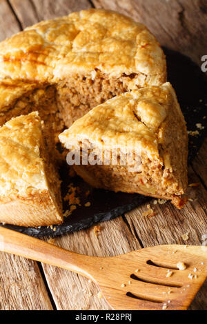 Christmas tourtiere spicy pie with pork, mashed potatoes and spices close-up on the table. vertical Stock Photo