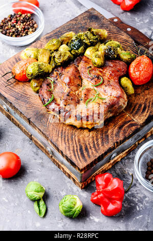 Grilled meat barbecue steak with brussels sprouts.Roast pork meat.Barbecue dish. Stock Photo