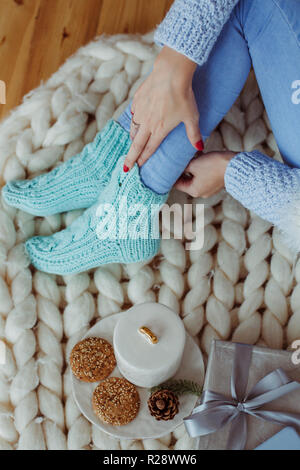 Woman's legs in winter socks.  Breakfast at home in bed. Stock Photo