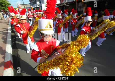 Kids musicians performed during the Higantes (Giant) effigy marches on the streets town of Angono province of Rizal on November 18, 2018. Higantes (Giant) Festival is celebrated November in the city of Angono, Province of Rizal in the Philippines to honor San Clemente, the patron saint of fishermen. The festival features a parade of hundreds of higantes, papier-mâché giants. Higantes (Giant) are puppets rendered as man or woman in various costumes; their face gives a commanding look, their hands on the waist. (Photo by Gregorio B. Dantes Jr./Pacific Press) Stock Photo