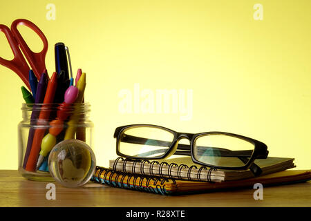BACK TO SCHOOL CONCEPT: School stationeries over a yellow background. Copy Space Stock Photo