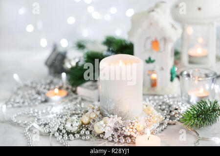 White candle on holiday silver background, Christmas concept Stock Photo