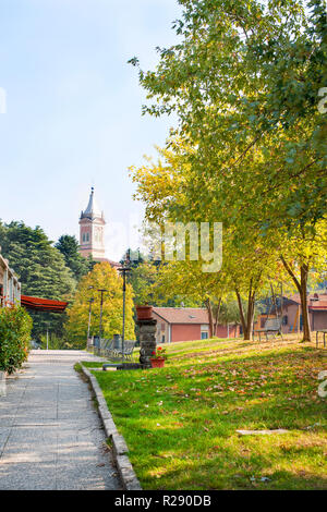 Autumn park in Italy. Old buildings, trees and blue sky. Beautiful nature in evroppe