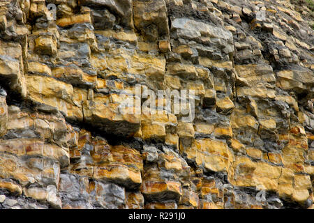 Layers of rock strata in the unstable cliff face at Nash Point, South Wales, UK Stock Photo