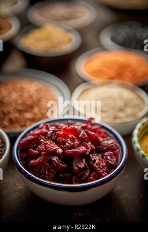 Dry cranberries in ceramic bowl. Selective focus Stock Photo