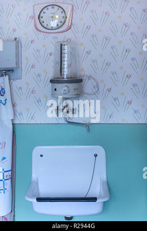 Wall clock, wall water boiler and sink in a 1950s kitchen, Lauf an der Pegnitz Industrial Museum, Middle Franconia, Bavaria Stock Photo