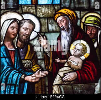 A stained glass window depicting the Presentation of Our Lord Jesus and the the Purification of the Blessed Virgin Mary. Stock Photo