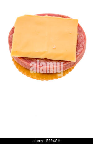 A cracker with summer sausage and cheese to make finger food