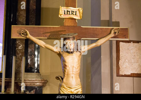 Jesus Christ on the cross in the San Vittore Martire Church (Church of Saint Victor Maurus the martyr). Stock Photo