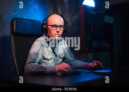 Happy young man with headset working at home. Stock Photo