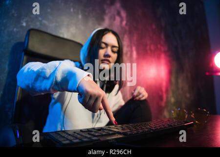 Woman hacker is ready to run malware program virus on the internet. Start hacking remote system computer. Stock Photo