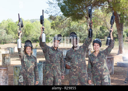 Portrait of paintball players wearing uniform and holding guns ready for playing outdoor Stock Photo