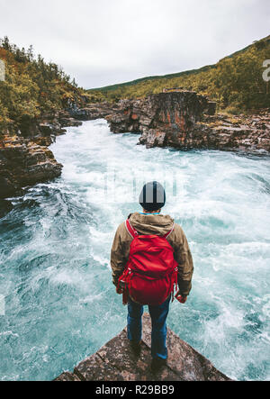 Man traveling with backpack enjoying view alone active lifestyle hiking at river canyon adventure vacations outdoor in Sweden Stock Photo