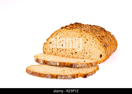 Loaf and slices of bread isolated on white background, front view, closeup. Stock Photo