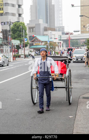 TOKYO, JAPAN - OCTOBER 3, 2016: Unidentified  rickshaw runner at Asakusa district in Tokyo, Japan. Rickshaws are believed to have been invented in Jap Stock Photo