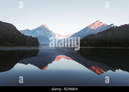 Peaceful autumn view on Obersee lake in Swiss Alps. Clear sky and mountains reflections in clear water. Nafels village, Switzerland. Stock Photo