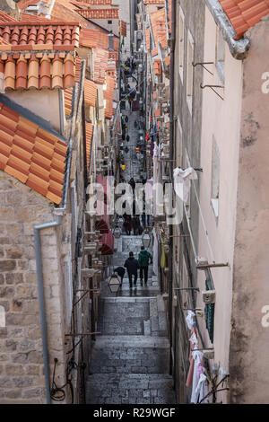 Dubrovnik, Croatia - January 1 2016:Aerial view of narrow alley sorrounded by orange roofs in Dubrovnik with tourists, Croatia Stock Photo