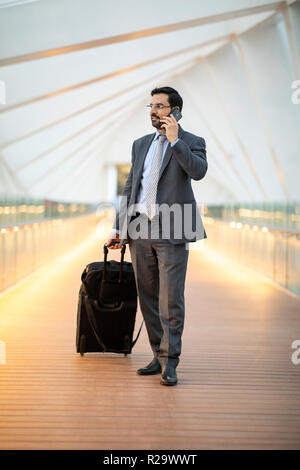 arab businessman with his suitcase in a city Stock Photo