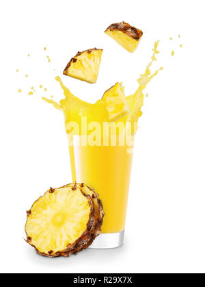 pineapple pieces falling into glass with juice and creating splashes isolated on white background Stock Photo
