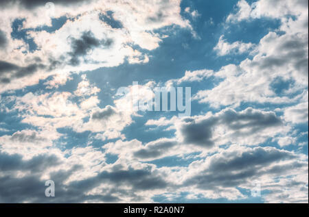 Summer bright sky with cumulus clouds and sun in the clouds Stock Photo