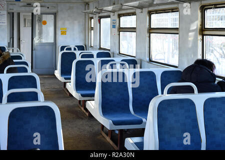 Old blue plastic seats in a suburban train in Moscow, Russia Stock Photo