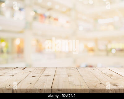 Empty wood table and Blurred background image. supermarket blur background with space display montage for product. Stock Photo