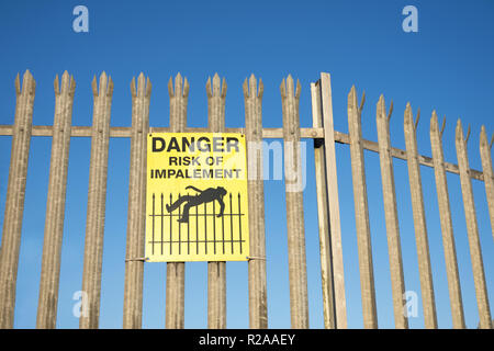 Impalement danger and risk sign on fence for security and protection ...