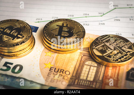 Golden  coins of crypto currency Bitcoin and Euro paper money Stock Photo