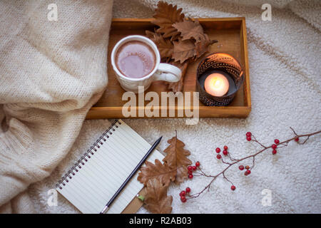 blank notebook with mug of coffee in bed Stock Photo