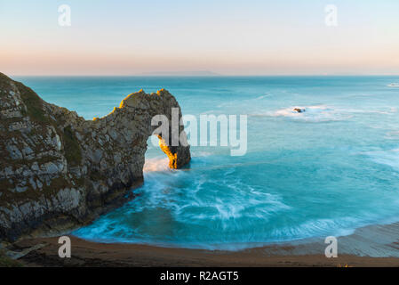 Lulworth, Dorset, UK.  18th November 2018.  The Limestone sea arch of Durdle Door on the Jurassic Coast of Dorset near Lulworth shortly after sunrise on a cold clear morning.  Picture Credit: Graham Hunt/Alamy Live News. Stock Photo