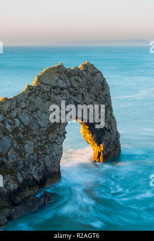Lulworth, Dorset, UK.  18th November 2018.  The Limestone sea arch of Durdle Door on the Jurassic Coast of Dorset near Lulworth shortly after sunrise on a cold clear morning.  Picture Credit: Graham Hunt/Alamy Live News. Stock Photo