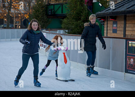 Edinburgh, Scotland. UK 18 Nov. 2018. the sunshine got people out to visit the  St Andrew's Square ice rink which had a slowish start but began to busy up for the afternoon. Stock Photo