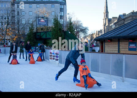 Edinburgh, Scotland. UK 18 Nov. 2018. the sunshine got people out to visit the  St Andrew's Square ice rink which had a slowish start but began to busy up for the afternoon. Stock Photo