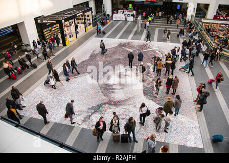 Birmingham, UK. 18th November 2018. A giant mosaic portrait of suffragette Hilda Burkitt  at Birmingham New Street station. The 20m (65ft) image is made up 3,724 selfies and other photos of women sent in from across the UK. The project, titled Face of Suffrage, is the brainchild of artist Helen Marshall and marks 100 years since the first British women voted. Credit: steven roe/Alamy Live News